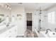 Bathroom featuring dual sinks, glass shower, and soaking tub at 7678 S Old Hammer Way, Aurora, CO 80016