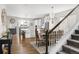 Dining room with seating for six is adjacent to the bright and modern kitchen and staircase at 7678 S Old Hammer Way, Aurora, CO 80016
