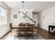 Warm dining area with a wooden table, seating for six, decor, hardwood floors, and a bright window at 7678 S Old Hammer Way, Aurora, CO 80016