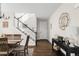 Warm entryway with hardwood floors, staircase, table, neutral walls, and stylish decor setting a welcoming tone at 7678 S Old Hammer Way, Aurora, CO 80016