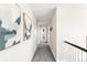 Hallway with neutral paint, gray carpet and decorative art at 7678 S Old Hammer Way, Aurora, CO 80016