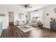 Comfortable living room with neutral tones, large window, plush seating, and hardwood floors at 7678 S Old Hammer Way, Aurora, CO 80016