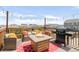 Inviting rooftop deck with a fire pit, grill, and comfortable seating for outdoor entertaining at 7678 S Old Hammer Way, Aurora, CO 80016