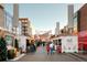 A festive holiday market with decorated vendor stalls, offering a variety of seasonal gifts and treats at 277 S Jackson St, Denver, CO 80209