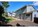 The backyard features a well-kept lawn, a patio area, and a fence providing privacy and defining the backyard space at 7822 W Ottawa Pl, Littleton, CO 80128