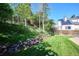 The fenced backyard offers an inviting lawn and landscaped hillside, perfect for outdoor enjoyment at 7822 W Ottawa Pl, Littleton, CO 80128