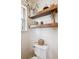 Powder room featuring floating wood shelves and neutral decor at 7822 W Ottawa Pl, Littleton, CO 80128