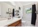 Bright bathroom featuring updated vanity, storage, and tub shower at 7822 W Ottawa Pl, Littleton, CO 80128