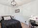 Cozy bedroom featuring modern light fixture and wainscoting at 7822 W Ottawa Pl, Littleton, CO 80128