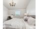 Bright and airy bedroom with neutral walls, plush carpeting, and a cozy reading nook at 7822 W Ottawa Pl, Littleton, CO 80128