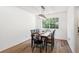 Bright dining room with hardwood floors, large windows, and modern light fixture at 7822 W Ottawa Pl, Littleton, CO 80128