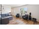 Cozy living room featuring hardwood floors, large windows, and comfortable seating at 7822 W Ottawa Pl, Littleton, CO 80128