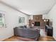 Comfortable living room featuring hardwood floors, brick fireplace, neutral colors, and a large window at 7822 W Ottawa Pl, Littleton, CO 80128