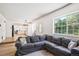 Open-concept living room showcasing hardwood floors and seamless flow into the kitchen and dining areas at 7822 W Ottawa Pl, Littleton, CO 80128