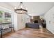 Cozy living room featuring hardwood floors, brick fireplace, neutral colors, and a large window at 7822 W Ottawa Pl, Littleton, CO 80128