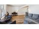 Open-concept living room featuring comfortable seating, hardwood floors, and bright natural light at 7822 W Ottawa Pl, Littleton, CO 80128