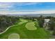 Aerial view featuring lush golf courses, a beautiful home, and picturesque views of the surrounding landscape at 120 Silver Leaf Way, Castle Rock, CO 80108