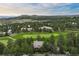 Panoramic aerial view of houses nestled among lush green golf course and trees at 120 Silver Leaf Way, Castle Rock, CO 80108