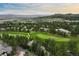 Houses nestled among trees and lush green golf course in scenic aerial image at 120 Silver Leaf Way, Castle Rock, CO 80108
