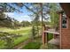 Beautiful golf course views from the outdoor balcony, surrounded by mature trees and landscaping at 120 Silver Leaf Way, Castle Rock, CO 80108