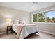 Inviting bedroom with ample natural light, a plush bed, side table and view from the window at 120 Silver Leaf Way, Castle Rock, CO 80108
