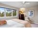 Bright bedroom with large windows, featuring an inviting bed, dresser, and tasteful decor for a peaceful ambiance at 120 Silver Leaf Way, Castle Rock, CO 80108