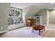 Bonus room featuring a large window, piano, built-in shelving, and a coffee table on a neutral rug at 120 Silver Leaf Way, Castle Rock, CO 80108