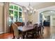 Formal dining room featuring hardwood floors, large windows, elegant chandelier, and classic furnishings at 120 Silver Leaf Way, Castle Rock, CO 80108