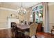Traditional dining room with fireplace, chandelier, and elegant furnishings, bathed in natural light from a large window at 120 Silver Leaf Way, Castle Rock, CO 80108