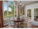 Dining room featuring hardwood floors, large windows offering natural light, and access to outdoor deck at 120 Silver Leaf Way, Castle Rock, CO 80108