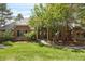 Charming brick home with a manicured lawn, mature trees, and a welcoming entrance at 120 Silver Leaf Way, Castle Rock, CO 80108