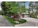 Charming brick home featuring mature trees, a well-manicured lawn and a two car garage at 120 Silver Leaf Way, Castle Rock, CO 80108