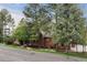 Brick home featuring mature trees, a well-manicured lawn, and a side facing front entry at 120 Silver Leaf Way, Castle Rock, CO 80108