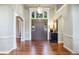 Elegant foyer with hardwood floors, arched doorways, high ceilings, and a large front door at 120 Silver Leaf Way, Castle Rock, CO 80108