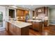 A modern kitchen featuring wood cabinetry, granite countertops, stainless steel appliances, and hardwood flooring at 120 Silver Leaf Way, Castle Rock, CO 80108