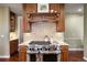 Gourmet kitchen with stainless steel range and hood, granite countertops, and custom wood cabinetry and trim at 120 Silver Leaf Way, Castle Rock, CO 80108