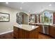 Gourmet kitchen with two islands, granite countertops, and stainless appliances, bright with natural light from large windows at 120 Silver Leaf Way, Castle Rock, CO 80108