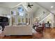 Bright living room with vaulted ceilings, hardwood floors, and a wall of windows offering scenic views at 120 Silver Leaf Way, Castle Rock, CO 80108