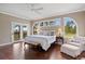 Bright main bedroom with hardwood floors, deck access, sitting area, and beautiful views at 120 Silver Leaf Way, Castle Rock, CO 80108
