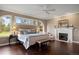 Main bedroom featuring hardwood floors, fireplace, sitting area, and large windows overlooking a green landscape at 120 Silver Leaf Way, Castle Rock, CO 80108