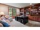 Home office with custom wood shelving, comfortable seating, and a large window for natural light at 120 Silver Leaf Way, Castle Rock, CO 80108