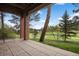 Covered patio with brick columns offering views of the manicured backyard at 120 Silver Leaf Way, Castle Rock, CO 80108
