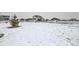 Snow-covered backyard featuring a large lot, fencing, and outbuildings at 9904 E 161St Pl, Brighton, CO 80602