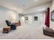 Spacious carpeted basement with recessed lighting, furniture, and artwork at 9904 E 161St Pl, Brighton, CO 80602