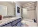 Modern bathroom with granite countertop vanity and tiled shower with sliding glass door at 9904 E 161St Pl, Brighton, CO 80602