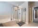 Modern bathroom featuring a glass-enclosed shower, soaking tub, and tile flooring at 9904 E 161St Pl, Brighton, CO 80602