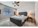 Comfortable bedroom featuring a king-size bed with a tufted headboard and ceiling fan at 9904 E 161St Pl, Brighton, CO 80602