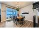 Charming dining room featuring modern light fixtures, wood floors, and sliding glass door at 9904 E 161St Pl, Brighton, CO 80602