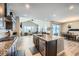 View of an open-concept living area featuring a modern kitchen, living room, and dining area at 9904 E 161St Pl, Brighton, CO 80602