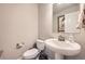 Stylish powder room features a pedestal sink, modern fixtures, and fresh decor at 9904 E 161St Pl, Brighton, CO 80602